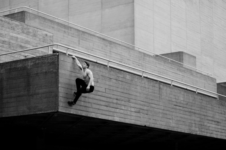Tim Shieff hanging off a parapet